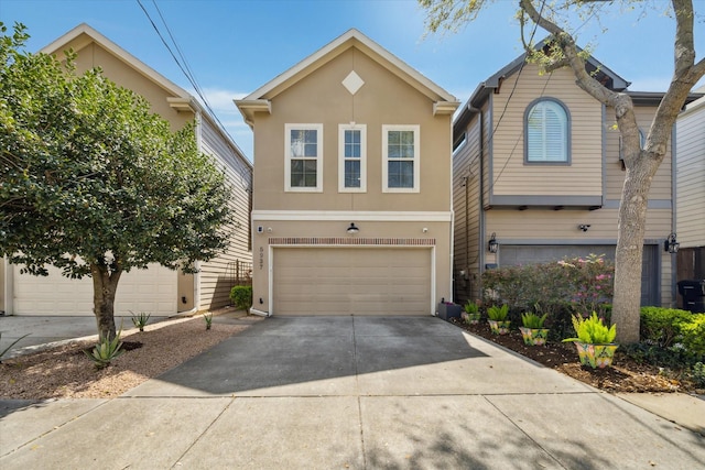 view of front of property with stucco siding, an attached garage, and concrete driveway