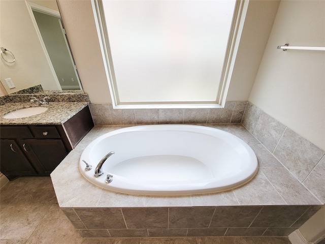 full bathroom featuring vanity and a garden tub