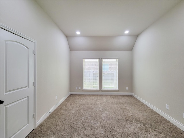 carpeted empty room with recessed lighting, baseboards, and lofted ceiling