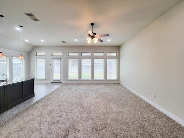 unfurnished living room with visible vents, light carpet, recessed lighting, light tile patterned floors, and ceiling fan