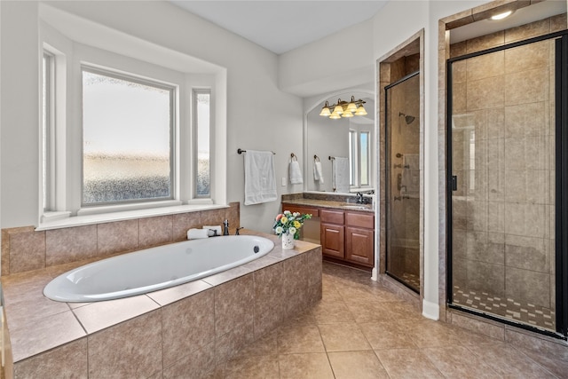 bathroom featuring a garden tub, a shower stall, vanity, and tile patterned flooring