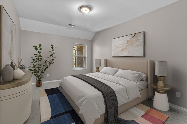 bedroom with visible vents, baseboards, carpet flooring, and vaulted ceiling