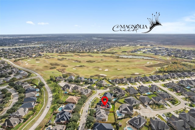 birds eye view of property featuring view of golf course, a residential view, and a water view