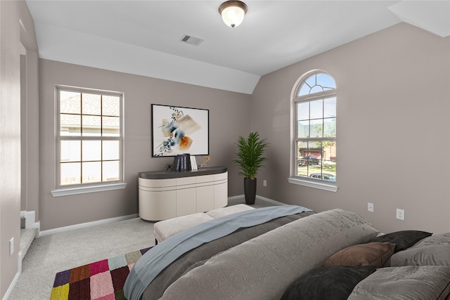 bedroom featuring vaulted ceiling, visible vents, baseboards, and carpet floors