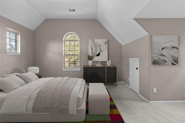 carpeted bedroom with vaulted ceiling, baseboards, and visible vents