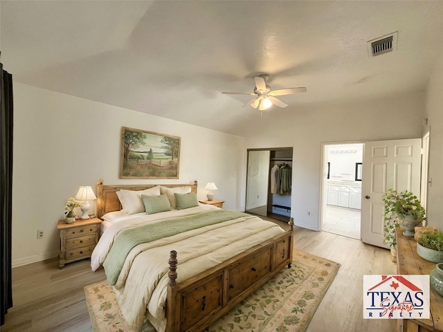 bedroom with light wood finished floors, visible vents, a ceiling fan, and a closet