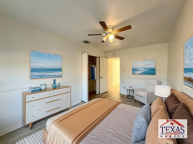 bedroom with visible vents, baseboards, light wood-style floors, and a ceiling fan