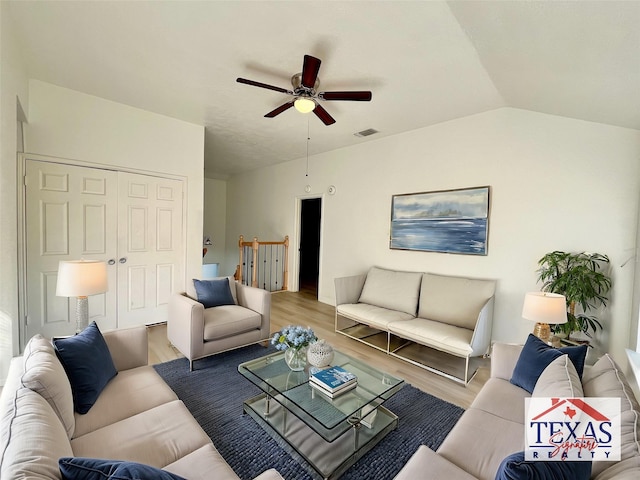 living area with wood finished floors, a ceiling fan, visible vents, and vaulted ceiling