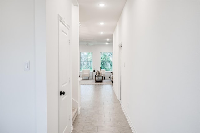 corridor featuring recessed lighting and baseboards