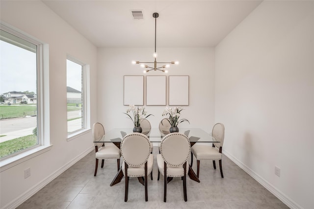 dining space featuring light tile patterned floors, visible vents, baseboards, and a chandelier