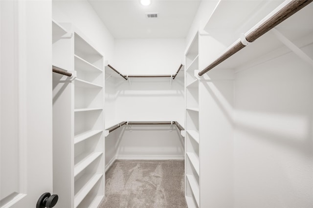 walk in closet with visible vents and carpet floors