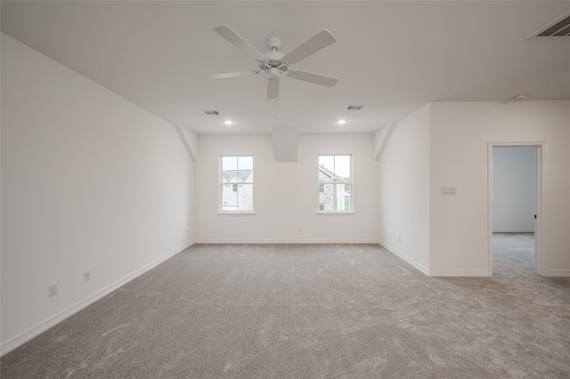 carpeted empty room featuring visible vents, baseboards, and a ceiling fan