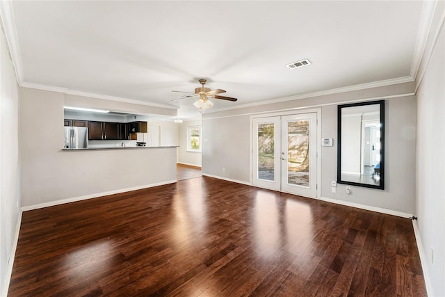 unfurnished living room with visible vents, ornamental molding, a ceiling fan, dark wood finished floors, and baseboards