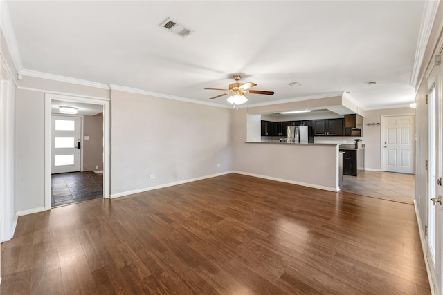 unfurnished living room with visible vents, ornamental molding, a ceiling fan, dark wood-style floors, and baseboards