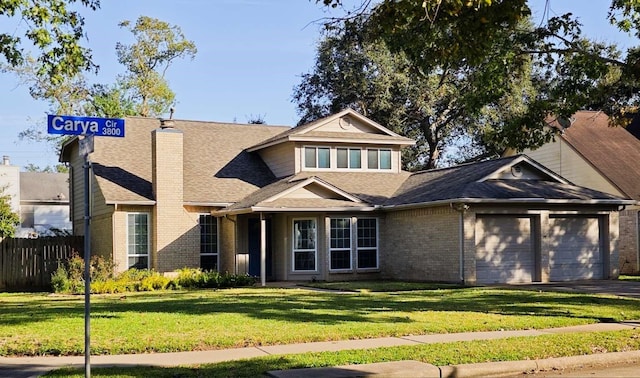 view of front of property featuring fence, roof with shingles, a front yard, a garage, and brick siding