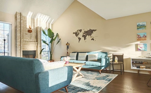 living room with vaulted ceiling, a brick fireplace, wood finished floors, and baseboards