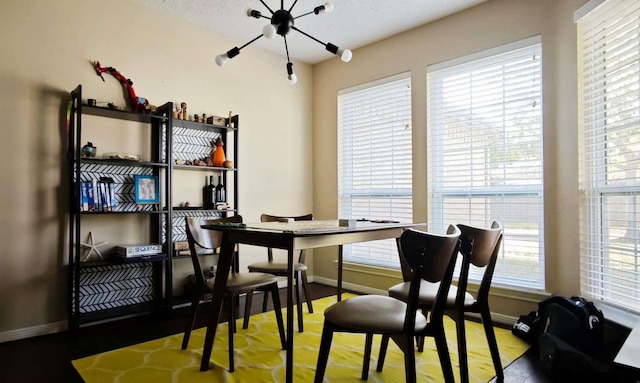 dining space with baseboards and an inviting chandelier