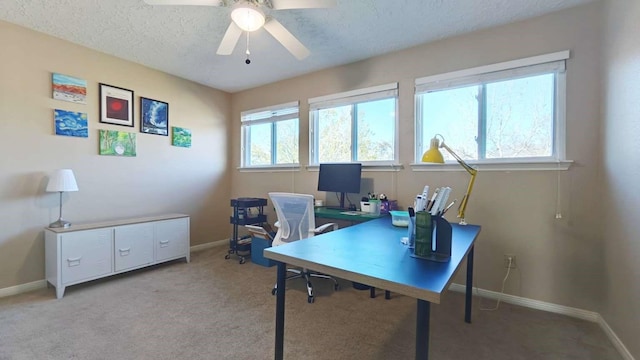 office space with a textured ceiling, baseboards, and ceiling fan