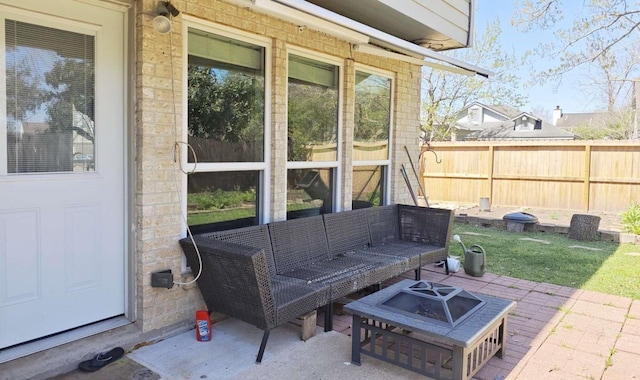 view of patio / terrace featuring a fire pit and fence