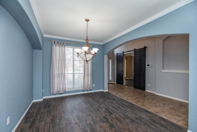 unfurnished dining area featuring dark wood finished floors, arched walkways, crown molding, a barn door, and a chandelier