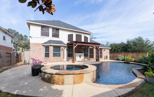 rear view of house featuring a patio area, a pergola, a fenced backyard, and brick siding