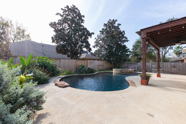 view of pool featuring a fenced backyard, a pool with connected hot tub, and a patio