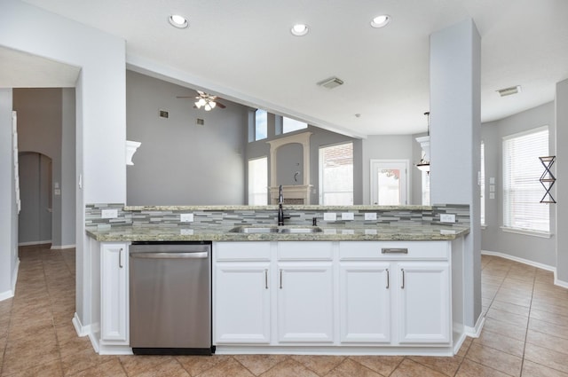 kitchen with light stone counters, white cabinetry, ceiling fan, a sink, and stainless steel dishwasher