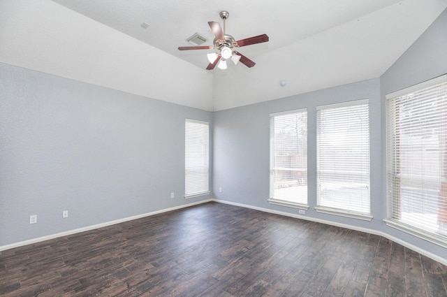 unfurnished room featuring visible vents, baseboards, vaulted ceiling, a ceiling fan, and dark wood-style flooring