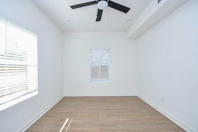 spare room with wood finished floors, baseboards, and ceiling fan