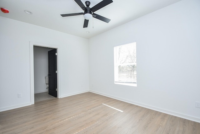 unfurnished room with light wood-style flooring, baseboards, and ceiling fan