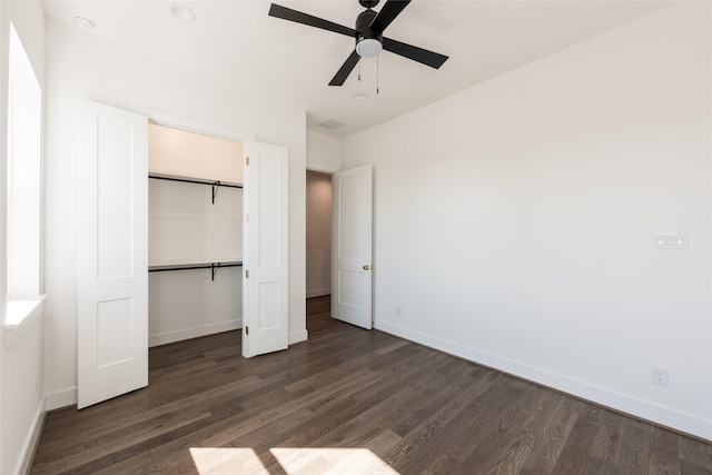 unfurnished bedroom featuring a closet, baseboards, dark wood finished floors, and a ceiling fan