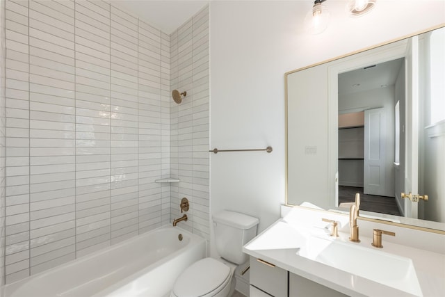 bathroom with tub / shower combination, toilet, and vanity