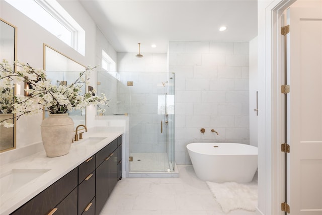 bathroom featuring double vanity, a stall shower, a freestanding bath, a sink, and marble finish floor