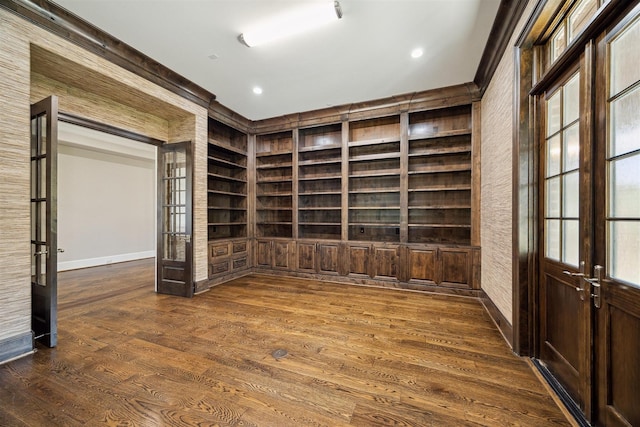 unfurnished room featuring dark wood-type flooring, built in shelves, and french doors