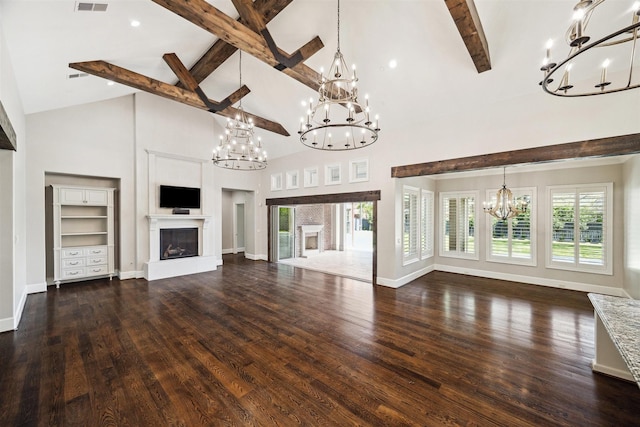 unfurnished living room featuring dark wood-style floors, baseboards, an inviting chandelier, a glass covered fireplace, and beamed ceiling