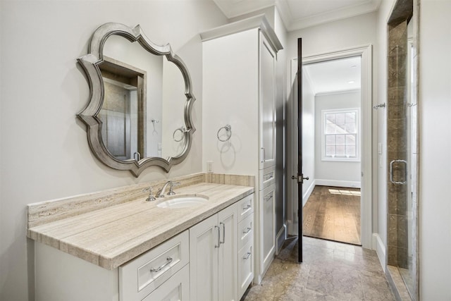 full bathroom featuring baseboards, ornamental molding, and vanity