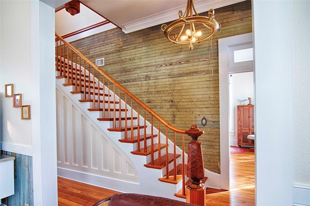 317 S Penn St, Flatonia, TX 78941 - staircase with a chandelier, wood finished floors, and wooden walls