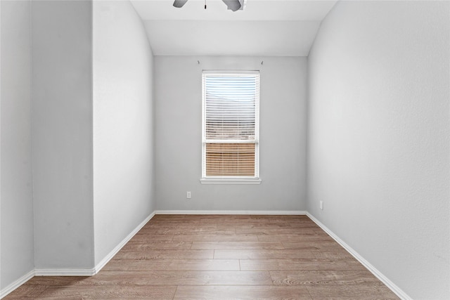 empty room with baseboards, a ceiling fan, and wood finished floors