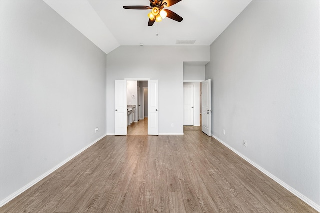 unfurnished bedroom with baseboards, visible vents, light wood finished floors, lofted ceiling, and ceiling fan