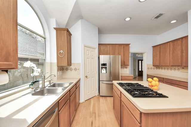 kitchen with a sink, visible vents, appliances with stainless steel finishes, and light countertops