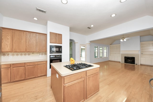 kitchen with visible vents, black appliances, ceiling fan, and light countertops