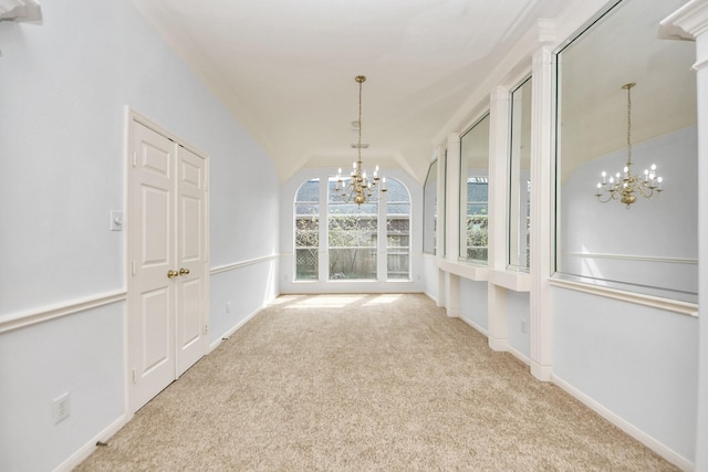 interior space with a notable chandelier and vaulted ceiling