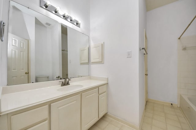 bathroom with vanity, baseboards, shower / washtub combination, tile patterned floors, and toilet