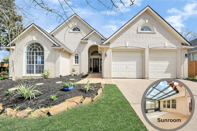 view of front of house featuring concrete driveway, an attached garage, and brick siding