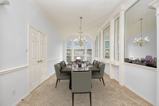 carpeted dining room featuring baseboards, a chandelier, and vaulted ceiling