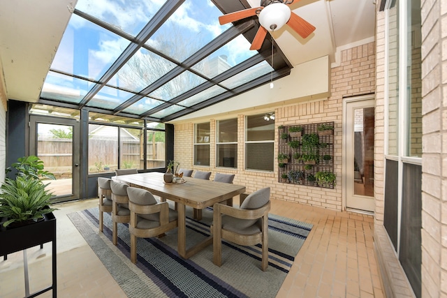 sunroom / solarium with a ceiling fan and vaulted ceiling