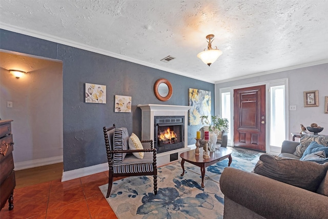 living area with crown molding, visible vents, and a textured ceiling