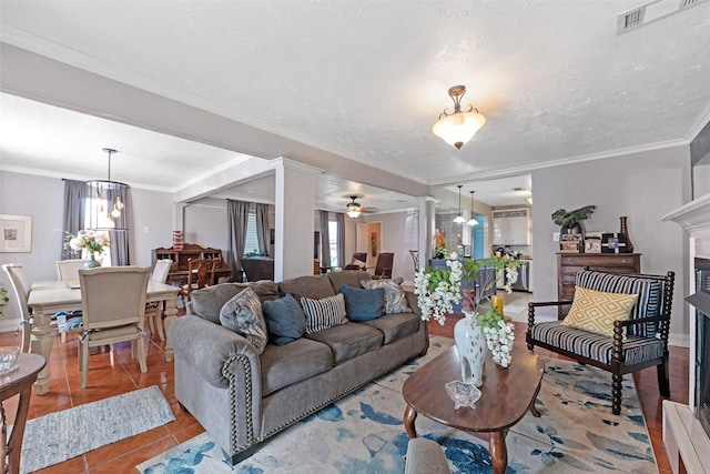 tiled living room featuring visible vents, a textured ceiling, a ceiling fan, and ornamental molding