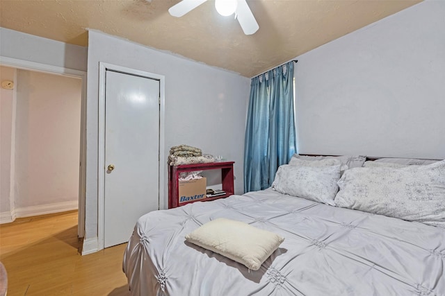 bedroom featuring a ceiling fan and wood finished floors