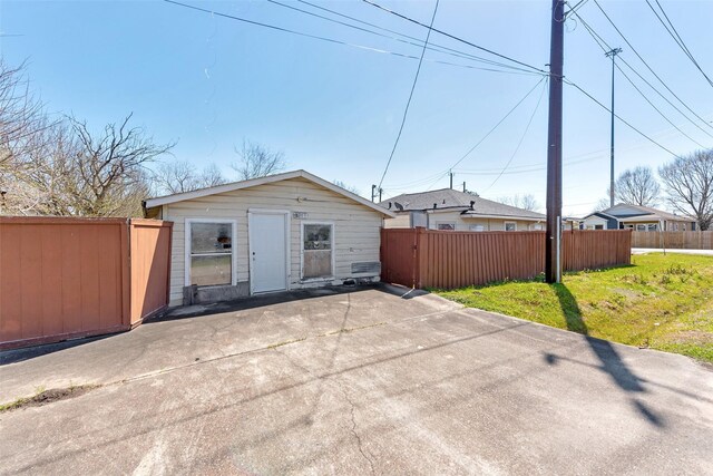 back of property featuring fence